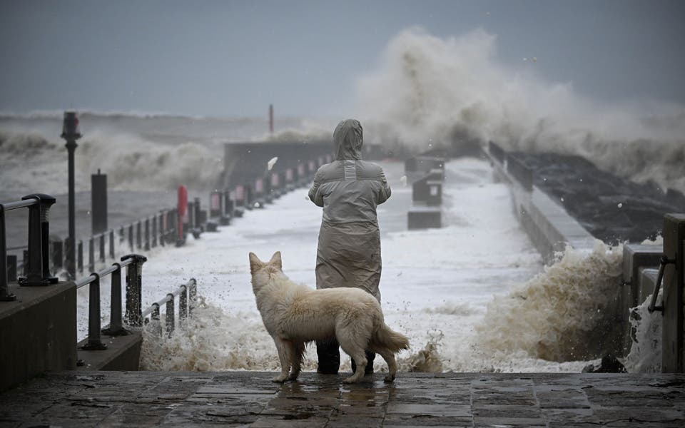 Thousands without power and flood warnings issued as 100mph winds hit